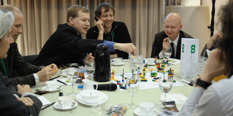 Group of participants co-creating a shared LEGO landscape